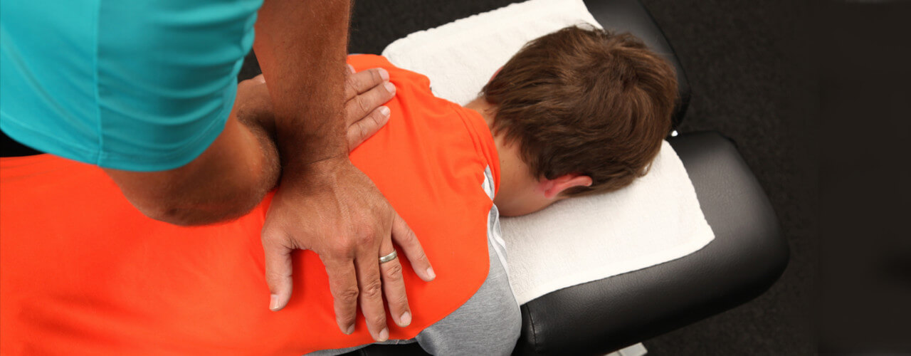 Chiropractor adjusts patient's back