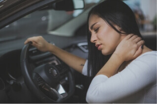 A woman suffering from neck pain after a motor vehicle accident.