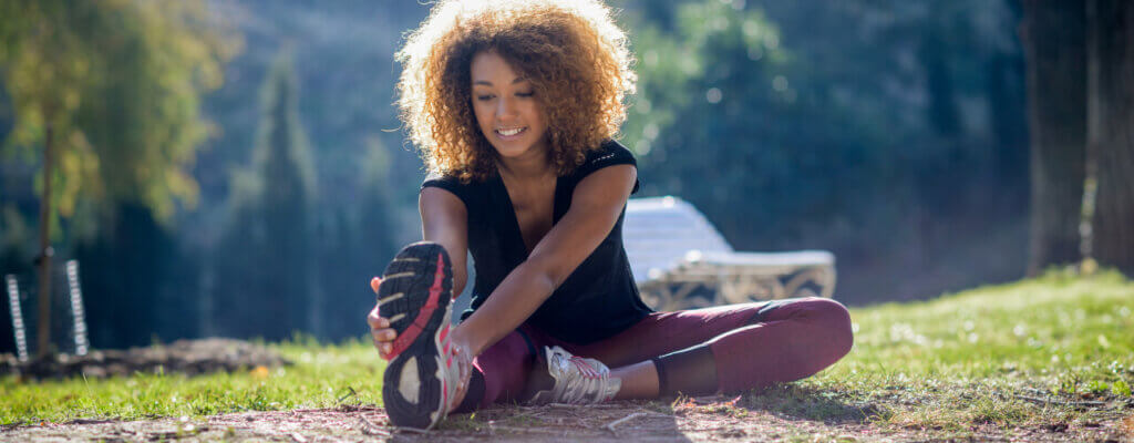 A woman who is stretching before exercise.