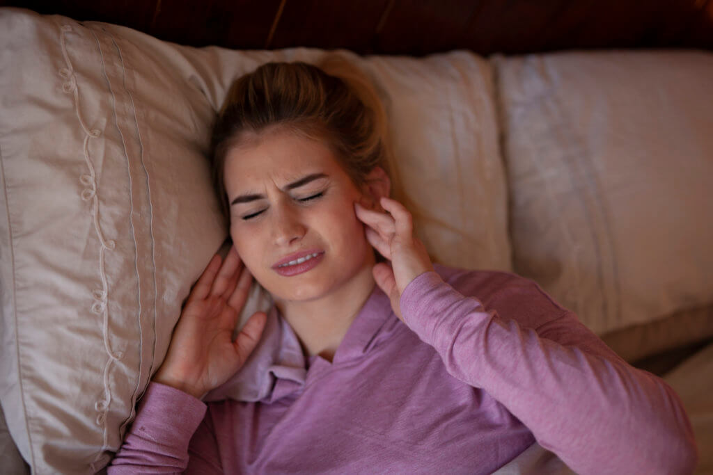 Woman waking up from TMJ Dysfunction